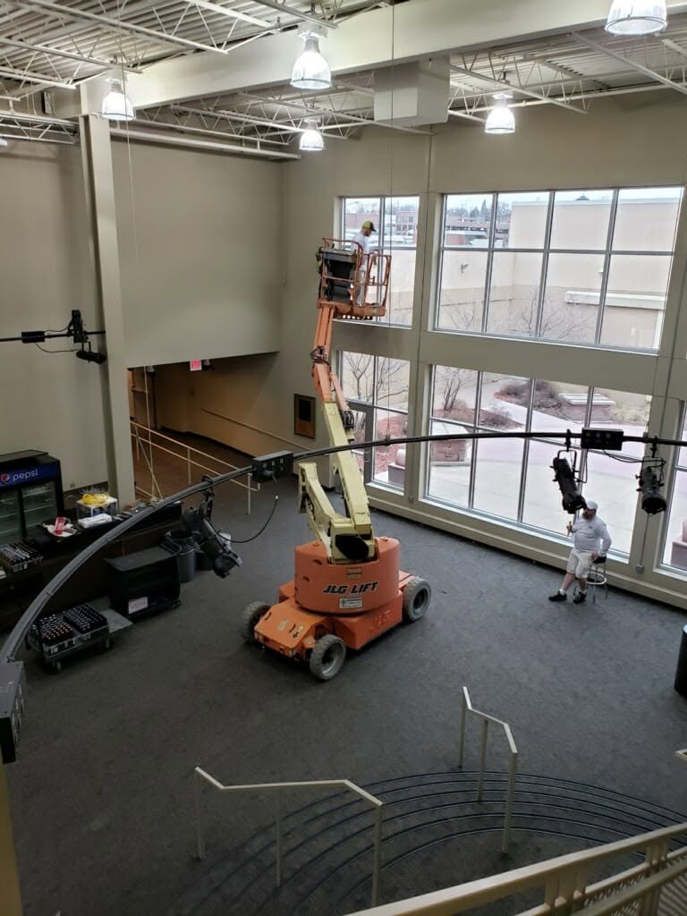Working the two-story window wall from a boom lift.